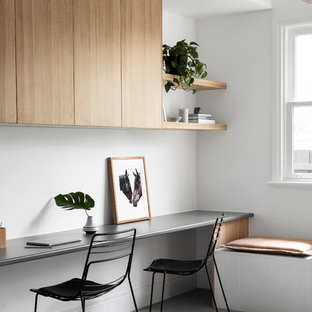 Inspiration for a mid-sized beach style study room in Melbourne with white walls, carpet, grey floor and a built-in desk.