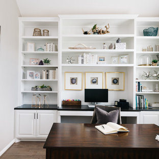 Beach style freestanding desk dark wood floor and brown floor study room photo in Houston with gray walls and no fireplace