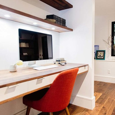 Study room - contemporary built-in desk dark wood floor and brown floor study room idea in San Francisco with white walls