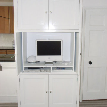 bespoke cabinet hiding home computer and workstation