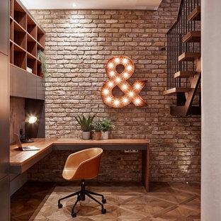 This is an example of a small urban study in London with light hardwood flooring, no fireplace and a built-in desk.