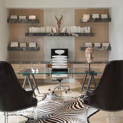 Example of a mid-sized trendy freestanding desk beige floor and light wood floor home office library design in Dallas with no fireplace and white walls