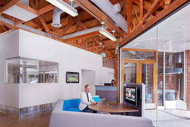Huge minimalist freestanding desk concrete floor home studio photo in Los Angeles with white walls