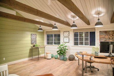 Example of a small mountain style freestanding desk light wood floor home studio design in Seattle with green walls