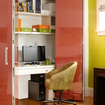 Small trendy built-in desk medium tone wood floor home office photo in San Francisco with green walls