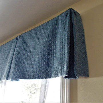 Box pleat valances enhanced with covered buttons in a quiet study