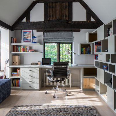Inspiration for a cottage built-in desk light wood floor study room remodel in London with white walls