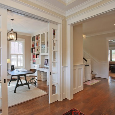 Home office - traditional freestanding desk medium tone wood floor home office idea in DC Metro with beige walls