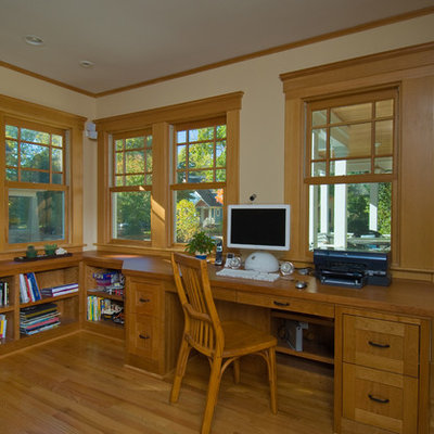 Mid-sized elegant built-in desk medium tone wood floor study room photo in Detroit with beige walls