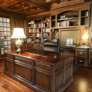 Design ideas for a mid-sized arts and crafts home office in Other with a library, brown walls, medium hardwood floors, no fireplace, a freestanding desk and brown floor.