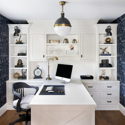 Home office - small coastal built-in desk medium tone wood floor and brown floor home office idea in Miami with blue walls and no fireplace