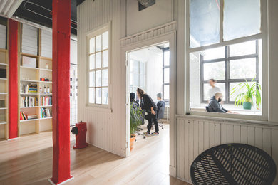 モントリオールにあるコンテンポラリースタイルのおしゃれなホームオフィス・書斎 (白い壁、淡色無垢フローリング、造り付け机) の写真