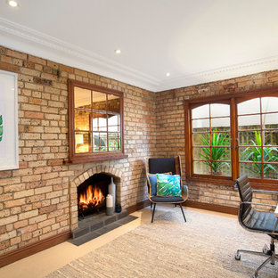 Eclectic study room in Sydney with carpet, a standard fireplace, a brick fireplace surround, a freestanding desk, beige floor and brown walls.