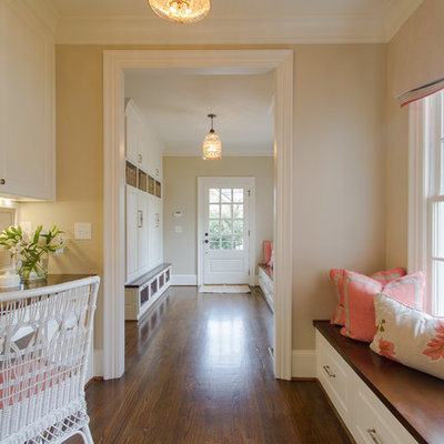 Elegant built-in desk brown floor home office photo in Atlanta with beige walls