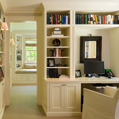 Example of a classic built-in desk home office design in Denver with beige walls