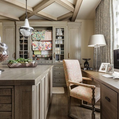 Inspiration for a timeless freestanding desk medium tone wood floor craft room remodel in Salt Lake City with beige walls