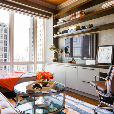 Example of a mid-sized trendy built-in desk medium tone wood floor study room design in Boston with brown walls