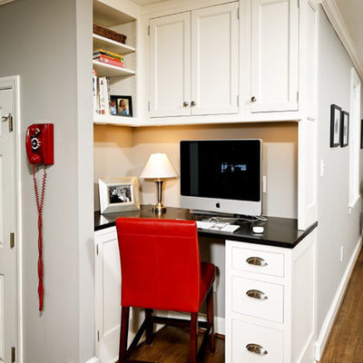 Elegant built-in desk home office photo in DC Metro with gray walls