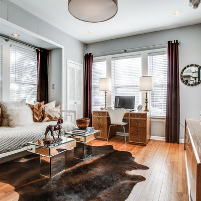 Home office - large transitional freestanding desk light wood floor home office idea in Dallas with gray walls and no fireplace