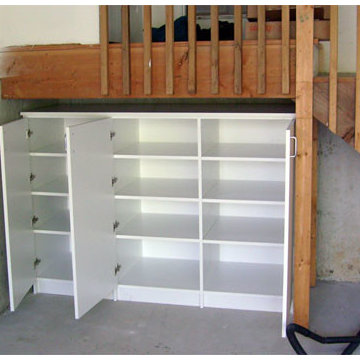 Closed office supplies storage cabinet under entry stairs