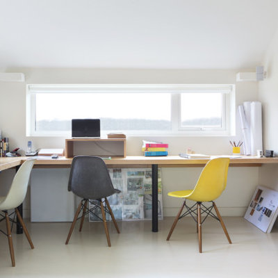 Large trendy built-in desk white floor study room photo in Oxfordshire with white walls