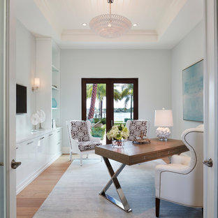 Example of a beach style freestanding desk light wood floor study room design in Miami with blue walls and no fireplace