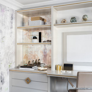 Inspiration for a large contemporary study in Surrey with carpet, a built-in desk, grey floors and white walls.