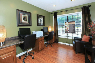 Inspiration for a mid-sized timeless built-in desk medium tone wood floor home office remodel in Atlanta with green walls