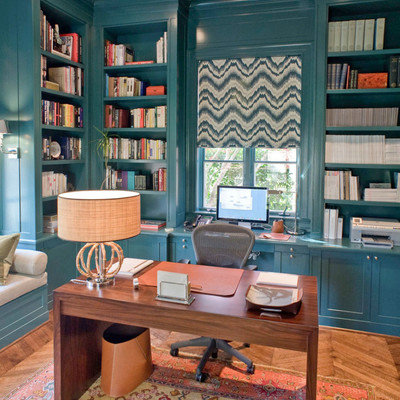 Small trendy built-in desk medium tone wood floor and brown floor study room photo in Dallas with blue walls and no fireplace