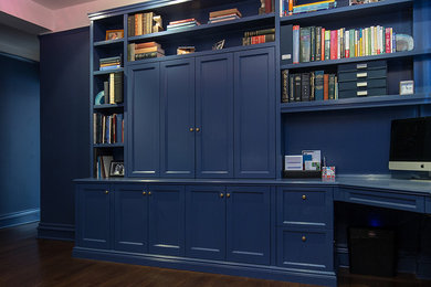 Diseño de despacho contemporáneo de tamaño medio sin chimenea con paredes azules, suelo de madera oscura y escritorio empotrado