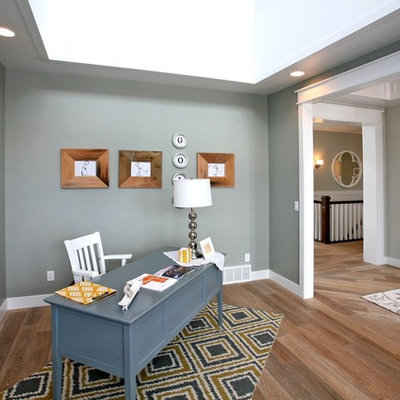 Example of a large trendy freestanding desk medium tone wood floor and brown floor study room design in Salt Lake City with gray walls and no fireplace