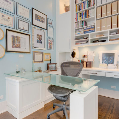 Example of a mid-sized trendy built-in desk medium tone wood floor and brown floor study room design in Chicago with blue walls