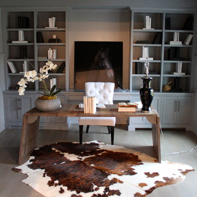 Trendy freestanding desk dark wood floor home office photo in New York