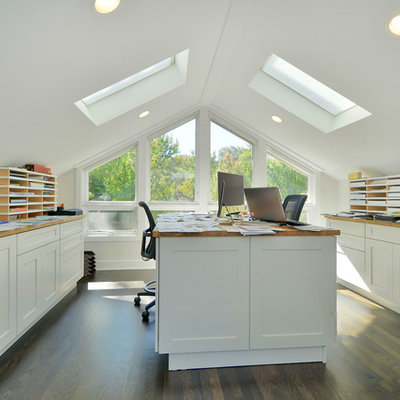 Large transitional built-in desk dark wood floor home studio photo in Chicago with white walls