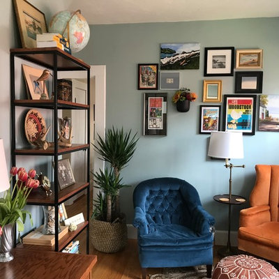 Home office library - mid-sized eclectic medium tone wood floor and brown floor home office library idea in Boston with green walls