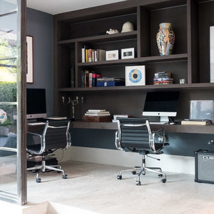 Photo of a small contemporary study in London with grey walls, a built-in desk and beige floors.