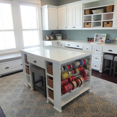 Example of a large classic built-in desk dark wood floor craft room design in Houston with blue walls
