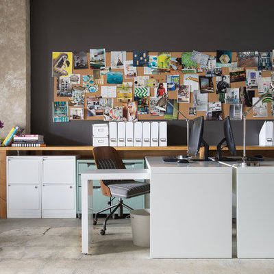 Trendy freestanding desk concrete floor study room photo in San Francisco with black walls