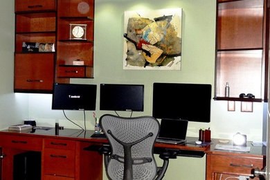 Inspiration for a mid-sized contemporary built-in desk carpeted study room remodel in Houston with green walls