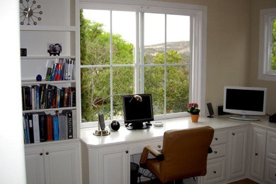 Example of a large classic built-in desk home office design in San Diego