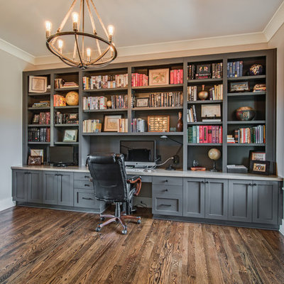 Example of a transitional built-in desk dark wood floor study room design in Charlotte with gray walls