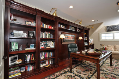 Study room - mid-sized traditional freestanding desk dark wood floor study room idea in Newark with beige walls and no fireplace