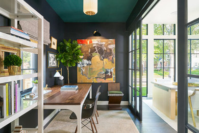 Contemporary study in Denver with black walls, dark hardwood flooring, a freestanding desk and brown floors.
