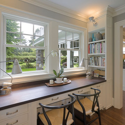 Home office - traditional built-in desk dark wood floor home office idea in Portland with gray walls