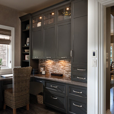 Example of a classic built-in desk medium tone wood floor home office design in Minneapolis with beige walls and no fireplace