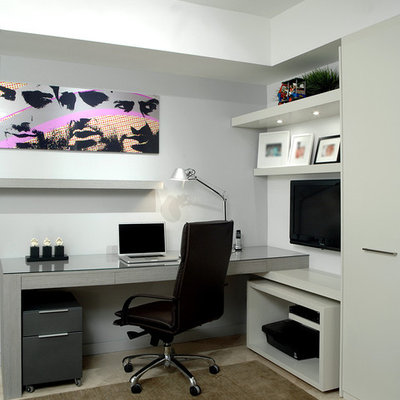 Example of a trendy built-in desk home office design in Miami with gray walls