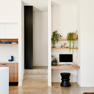 Inspiration for a small contemporary study room in Geelong with white walls, a built-in desk and grey floor.