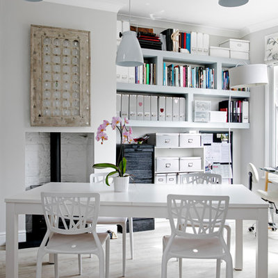 Example of a small classic freestanding desk home studio design in London with gray walls, a wood stove and a brick fireplace