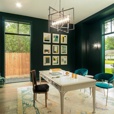 Home office library - transitional freestanding desk medium tone wood floor and brown floor home office library idea in Houston with green walls