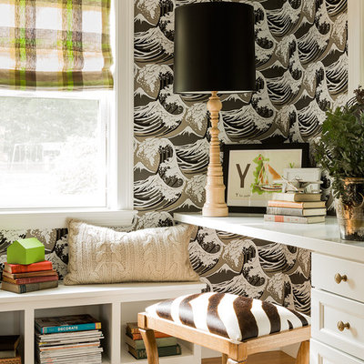 Example of an eclectic built-in desk medium tone wood floor home office design in Boston